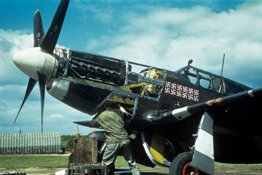 A member of the ground crew servicing the NA P-51B-5 Mustang 'Woodys Maytag' engine