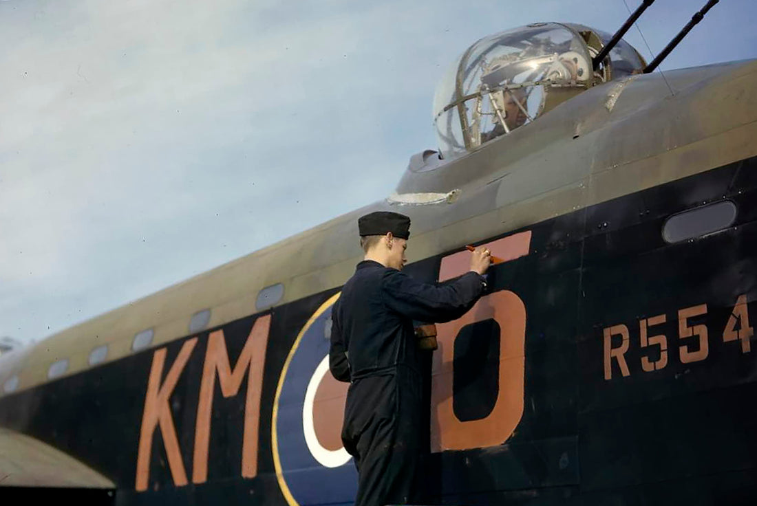 RAF technician repairs aircraft code on Avro Lancaster, Waddington, 1942